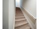 Carpeted staircase with white handrail leading to the upper level at 458 Bishop Ln, Woodstock, GA 30188