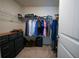 Spacious walk-in closet with ample shelving, hanging space, carpet floor and organized storage solutions at 458 Bishop Ln, Woodstock, GA 30188