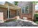 Brick house with brick patio and lush greenery, offering a private outdoor living space at 609 Pinetree Dr, Decatur, GA 30030