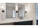 Contemporary bathroom features dual mirrors, vanity lighting, white countertop and black cabinetry at 609 Pinetree Dr, Decatur, GA 30030
