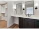 Bathroom vanity featuring dual mirrors with lighting, quartz counter tops and storage at 609 Pinetree Dr, Decatur, GA 30030