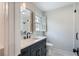 Bathroom featuring vanity with black cabinets, marble floors, quartz counters and glass shower at 609 Pinetree Dr, Decatur, GA 30030