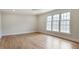 Bright bedroom featuring hardwood floors, neutral walls, large windows, and modern ceiling fan at 609 Pinetree Dr, Decatur, GA 30030