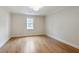Spacious bedroom with hardwood floors, natural light from a window, and neutral paint for a calming atmosphere at 609 Pinetree Dr, Decatur, GA 30030