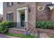Close-up of the home's entry, showing a decorative metal railing and brick steps at 609 Pinetree Dr, Decatur, GA 30030