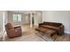 Cozy living room with hardwood floors, comfortable seating, and seamless flow into dining and kitchen areas at 609 Pinetree Dr, Decatur, GA 30030