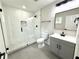 Updated bathroom featuring a glass-enclosed shower, modern fixtures, and stylish gray vanity at 6205 Hudson Nw St, Covington, GA 30014