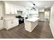 Modern kitchen features white cabinets, stainless steel appliances, and a center island at 6205 Hudson Nw St, Covington, GA 30014