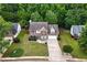 Aerial view of a two-story home with lush green surroundings and a well-maintained lawn in a serene neighborhood at 2086 Grant Ave, Mcdonough, GA 30252