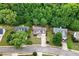 Aerial view of the home with a well-manicured lawn and mature trees at 2086 Grant Ave, Mcdonough, GA 30252