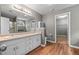 Bathroom featuring a dual sink vanity, large mirror, and walk-in closet at 2086 Grant Ave, Mcdonough, GA 30252