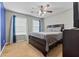 Neutral carpeted bedroom with a ceiling fan and big windows allowing natural light at 2086 Grant Ave, Mcdonough, GA 30252