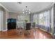 Elegant dining room with hardwood floors, modern chandelier, and a glass table set in a light-filled space at 2086 Grant Ave, Mcdonough, GA 30252