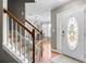 Inviting foyer with hardwood floors, staircase, and a view into the adjacent dining area with modern chandelier at 2086 Grant Ave, Mcdonough, GA 30252