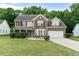 Charming two-story home with a well-manicured lawn and a two-car garage at 2086 Grant Ave, Mcdonough, GA 30252