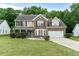 Charming two-story home with a well-manicured lawn, brick and siding exterior, and a two-car garage at 2086 Grant Ave, Mcdonough, GA 30252