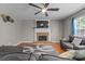 Cozy living room featuring a brick fireplace, modern TV, and comfortable seating in a relaxed setting at 2086 Grant Ave, Mcdonough, GA 30252
