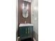 Stylish powder room featuring a modern vanity with gold fixtures and decorative wood slat wall at 2086 Grant Ave, Mcdonough, GA 30252