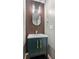 Stylish powder room featuring a modern vanity with gold fixtures and decorative wood accent wall at 2086 Grant Ave, Mcdonough, GA 30252