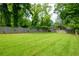 Spacious backyard with a large grassy area and a privacy fence at 437 E Ontario Sw Ave, Atlanta, GA 30310