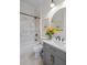 Stylish bathroom features a marble tiled shower/tub and a gray vanity at 437 E Ontario Sw Ave, Atlanta, GA 30310