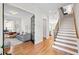 Bright entryway showcasing hardwood floors, staircase, and access to living spaces at 437 E Ontario Sw Ave, Atlanta, GA 30310