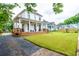 Beautifully renovated home featuring a large front yard, wide porch and a gravel driveway at 437 E Ontario Sw Ave, Atlanta, GA 30310