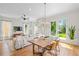 Bright living and dining area with hardwood floors, modern lighting, and backyard access at 437 E Ontario Sw Ave, Atlanta, GA 30310