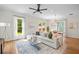Sunlit living space with hardwood floors, modern furnishings, and a view of the backyard at 437 E Ontario Sw Ave, Atlanta, GA 30310
