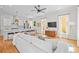 Open concept living room with a kitchen, hardwood floors, and lots of natural light at 437 E Ontario Sw Ave, Atlanta, GA 30310