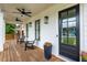 Inviting front porch features stylish seating, ceiling fans, and a sleek black front door at 437 E Ontario Sw Ave, Atlanta, GA 30310