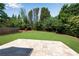 This backyard features a large grassy area with a stone patio in the foreground at 4769 Ellington Ct, Marietta, GA 30067