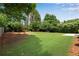 This backyard features a large grassy area with trees at 4769 Ellington Ct, Marietta, GA 30067