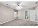Carpeted bedroom with a ceiling fan, bathroom access and natural light at 4769 Ellington Ct, Marietta, GA 30067