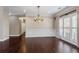 Formal dining room features hardwood floors, a chandelier, and large windows with plantation shutters at 4769 Ellington Ct, Marietta, GA 30067