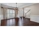 Classic dining room with hardwood floors, chandelier, and large plantation-shuttered windows near an arched entry and foyer at 4769 Ellington Ct, Marietta, GA 30067