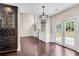 Bright dining room featuring a dark wood built in bar, hardwood floors, and french doors leading to the backyard at 4769 Ellington Ct, Marietta, GA 30067