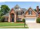 Beautiful brick home featuring manicured lawn and a two-car garage, with black shutters and mature landscaping at 4769 Ellington Ct, Marietta, GA 30067