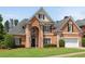 Charming brick home with manicured lawn, two-car garage, and black shutters, showing a warm and inviting exterior at 4769 Ellington Ct, Marietta, GA 30067