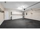 Spacious garage with black tile flooring, white cabinets, and an automatic door at 4769 Ellington Ct, Marietta, GA 30067