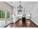 Spacious white kitchen features a dark center island, stainless steel appliances, and hardwood floors at 4769 Ellington Ct, Marietta, GA 30067