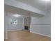 Open basement area with rustic fireplace and wood-look flooring at 5295 Old Trail Cir, Stone Mountain, GA 30088