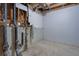 Unfinished basement with concrete walls, exposed piping, and basic utilities at 5295 Old Trail Cir, Stone Mountain, GA 30088