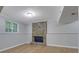 Basement space showcasing a unique stone fireplace and a bright window at 5295 Old Trail Cir, Stone Mountain, GA 30088