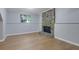 Basement living area featuring wood flooring and stone fireplace at 5295 Old Trail Cir, Stone Mountain, GA 30088