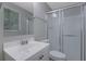 Well-lit bathroom featuring a modern vanity, shower, and a window bringing in natural light at 5295 Old Trail Cir, Stone Mountain, GA 30088