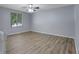 Spacious bedroom enhanced by smooth floors, a modern ceiling fan, and abundant natural light from a window at 5295 Old Trail Cir, Stone Mountain, GA 30088