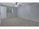 Bedroom with neutral carpet, ceiling fan, window, and bright natural light at 5295 Old Trail Cir, Stone Mountain, GA 30088