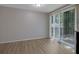 Dining room with sliding glass doors leading to a deck and wood flooring at 5295 Old Trail Cir, Stone Mountain, GA 30088