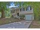 Charming split-level home with black shutters, a one-car garage, and a traditional front yard at 5295 Old Trail Cir, Stone Mountain, GA 30088